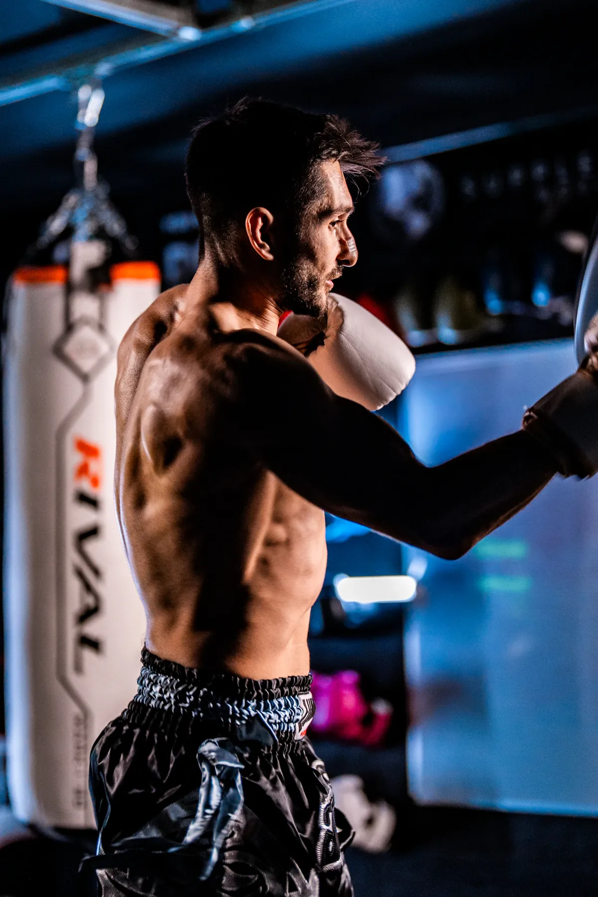 A boxer working with a punching bag in a real gym