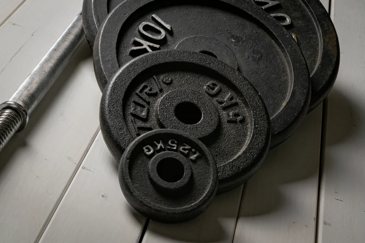Weight plates and a barbell, showing their metal surfaces