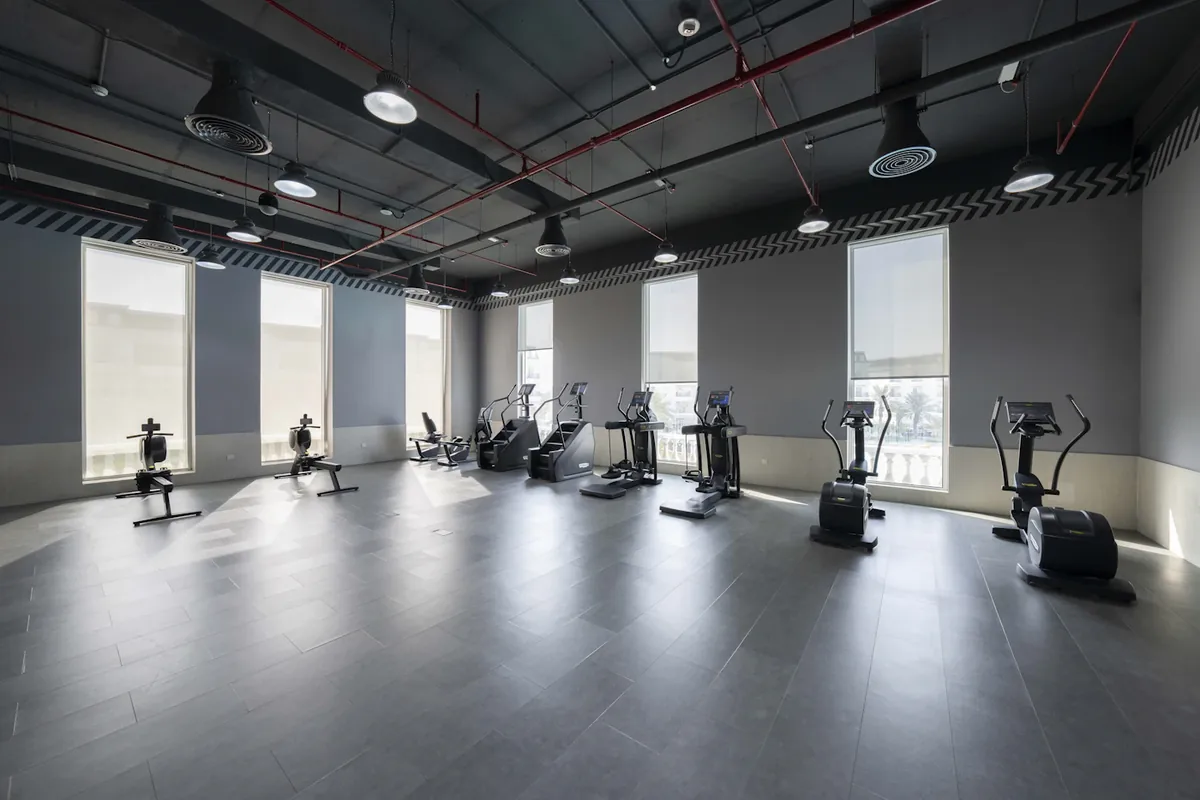 A spacious cardio training room with natural light